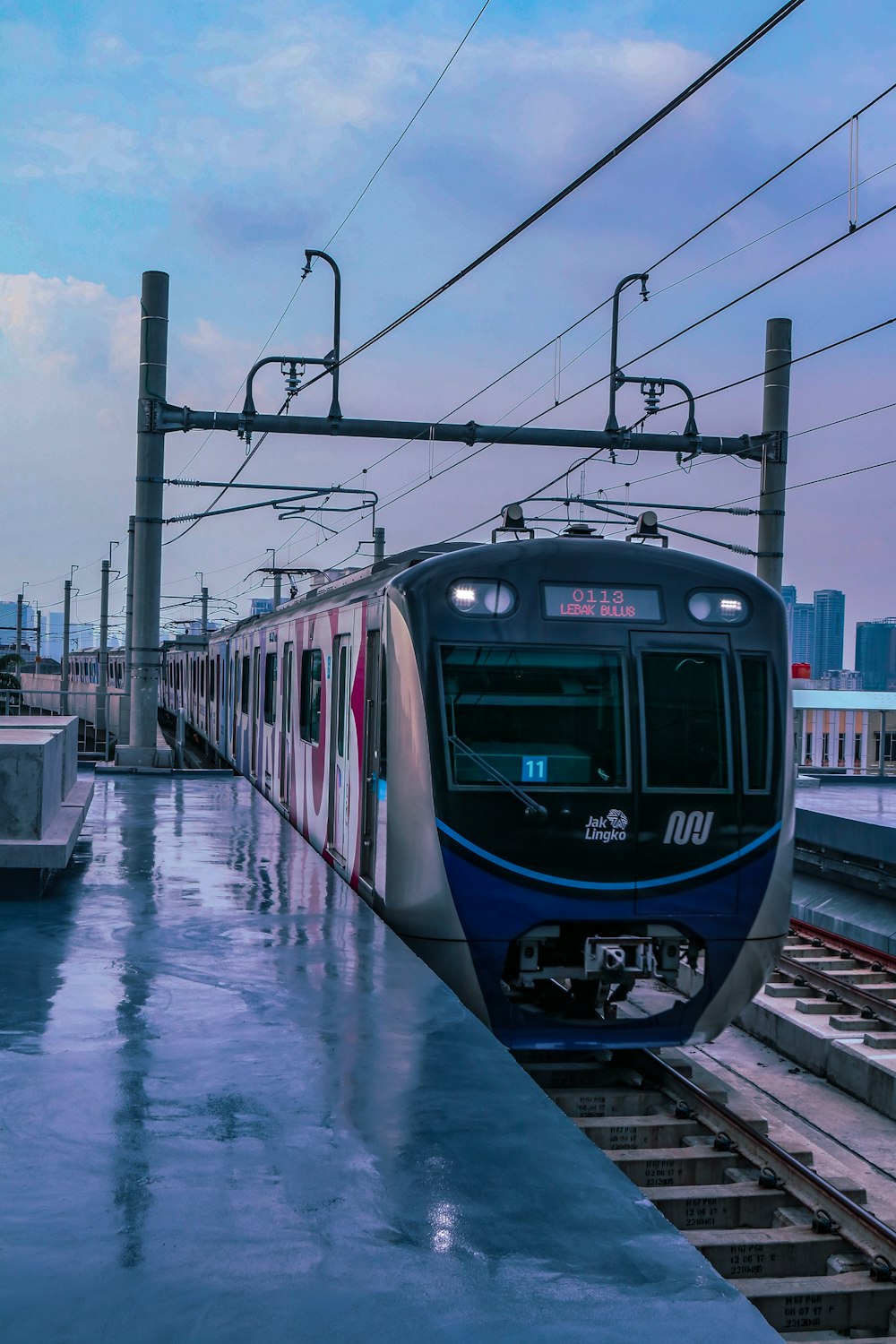 blue train on rail during daytime