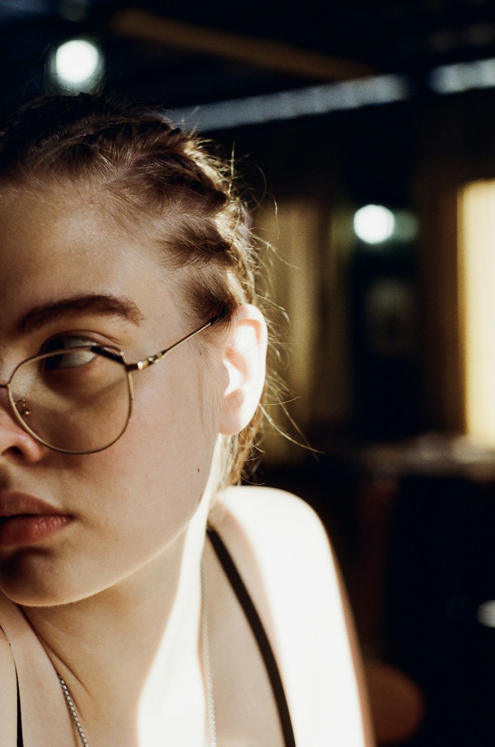 woman in white tank top wearing eyeglasses