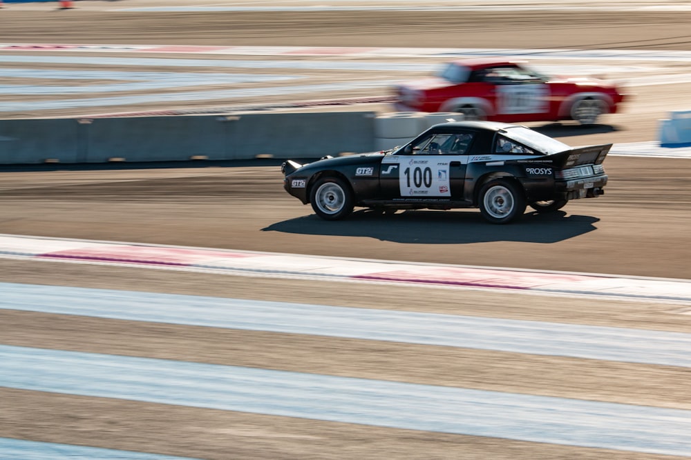 black and red racing car on track