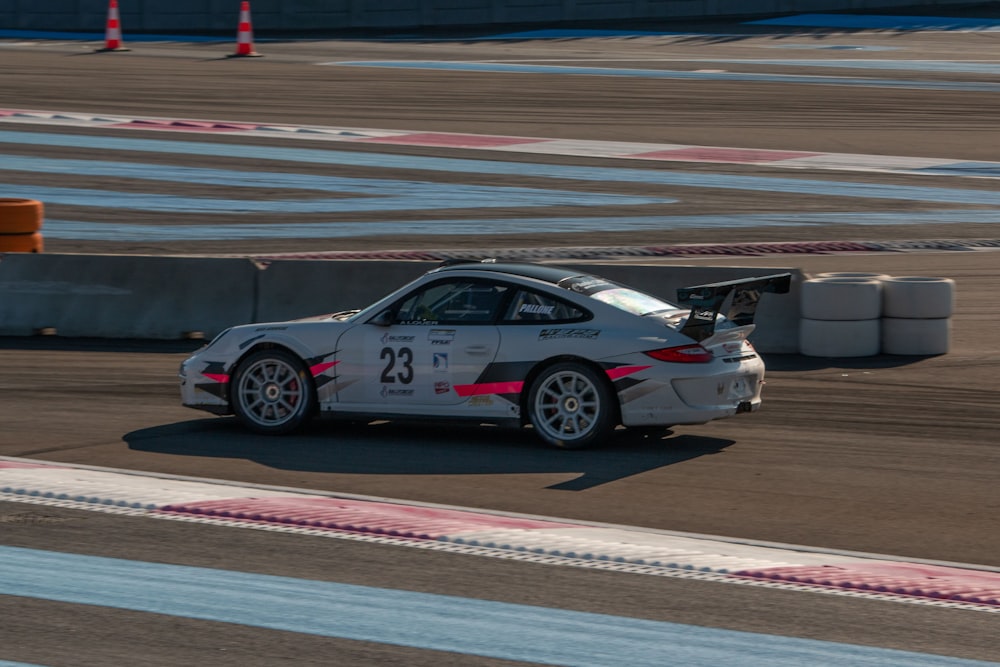 white and black sports car on track field during daytime