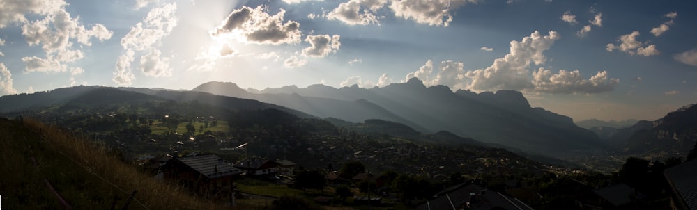 green mountains under white clouds and blue sky during daytime