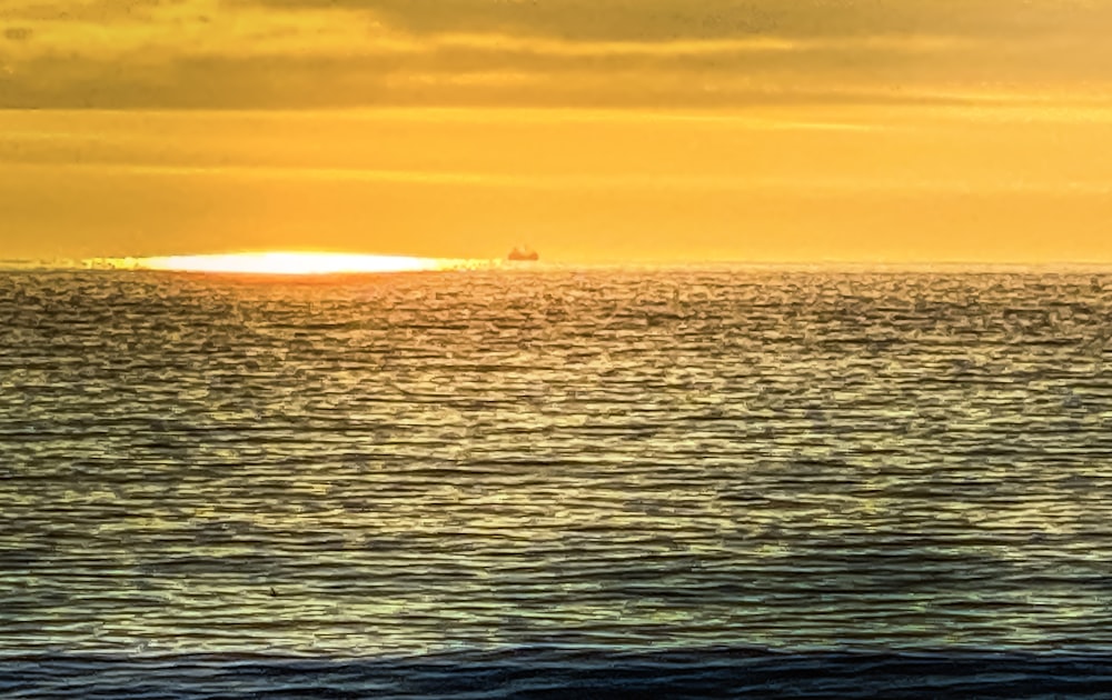 body of water during sunset