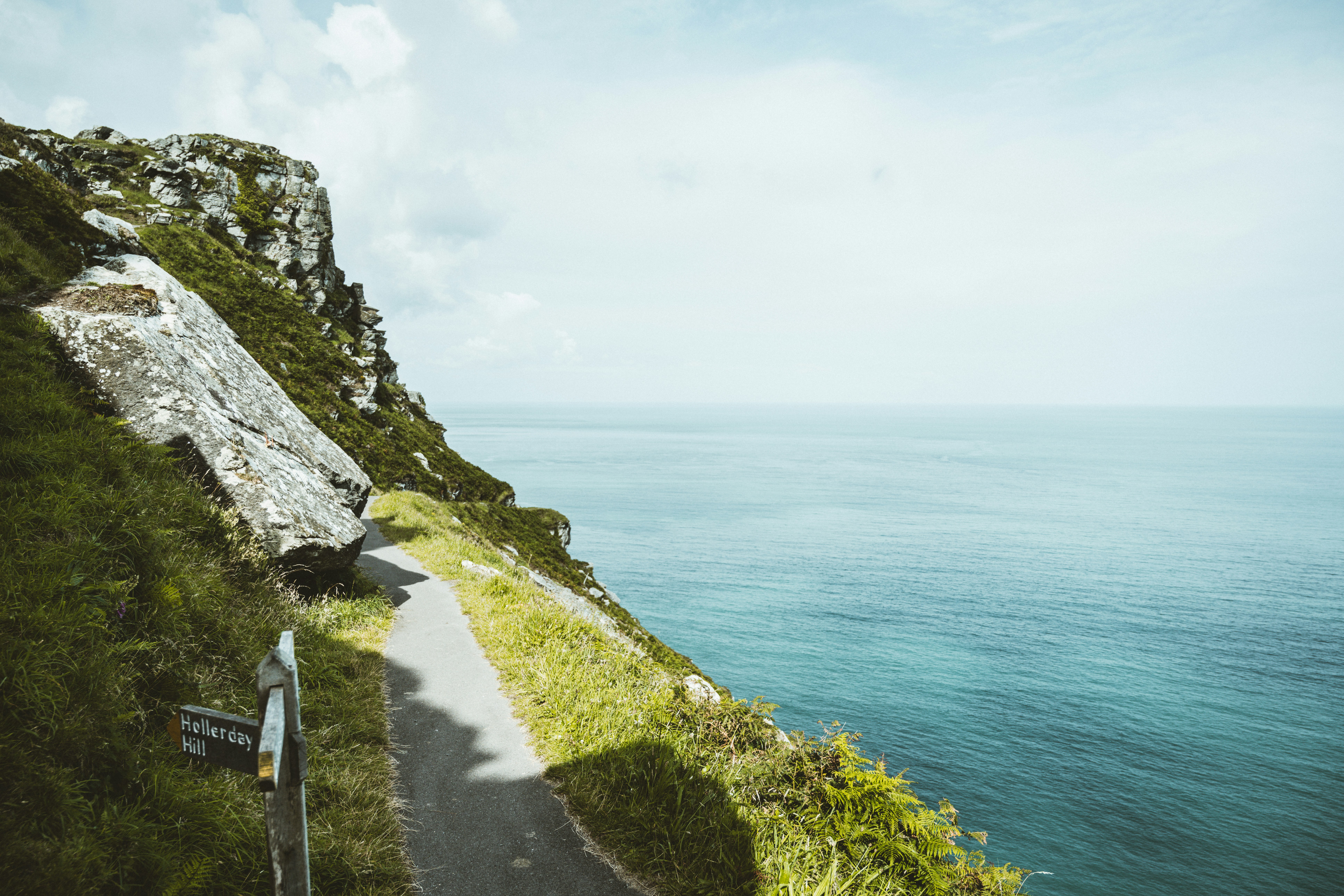 black bicycle on road near body of water during daytime