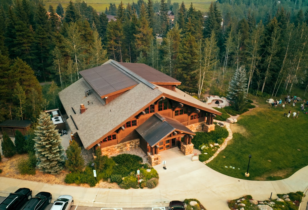 white car parked near brown and gray house, Wedding lodge tucked into the mountains