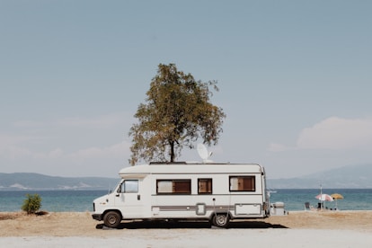 white and blue van on beach during daytime