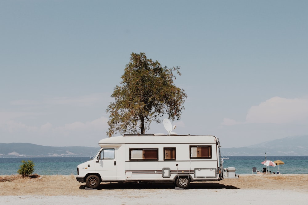 white and blue van on beach during daytime