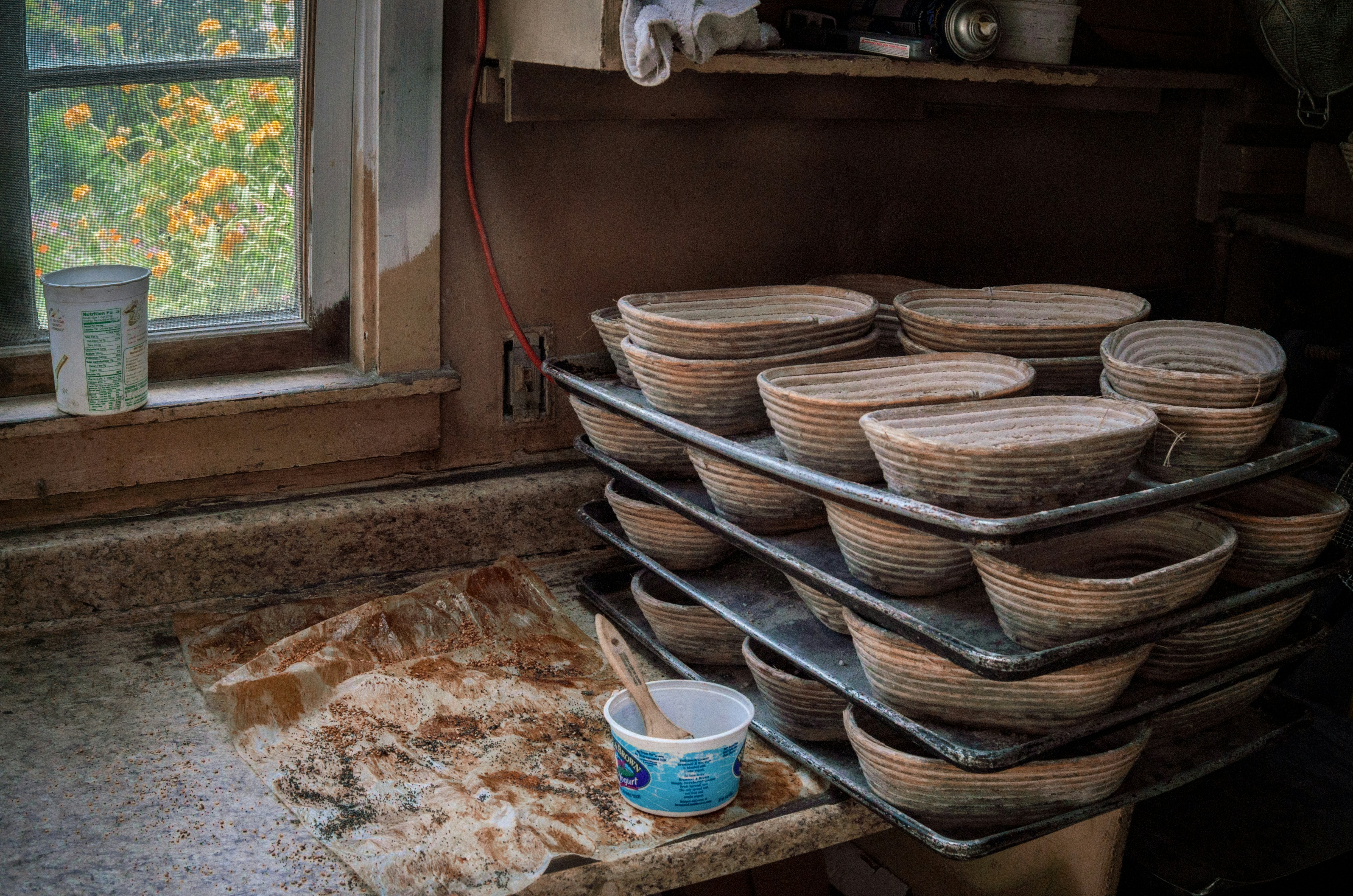 brown woven baskets on brown wooden shelf