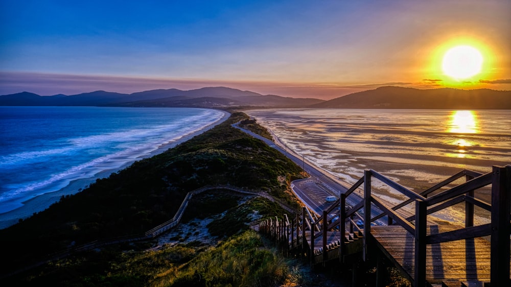 brown wooden bridge over the sea during daytime