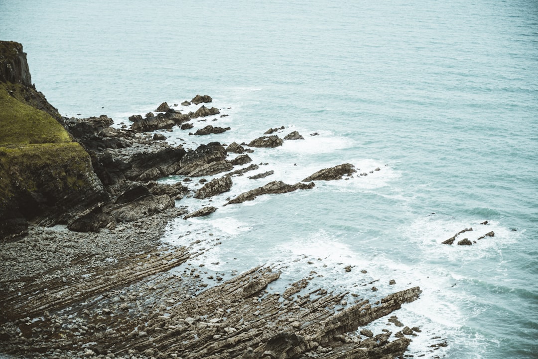 aerial view of sea waves crashing on shore during daytime