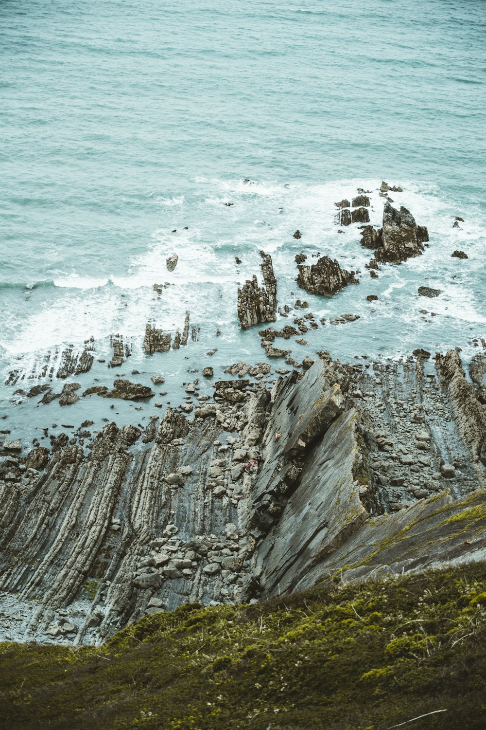 brown rock formation on sea during daytime