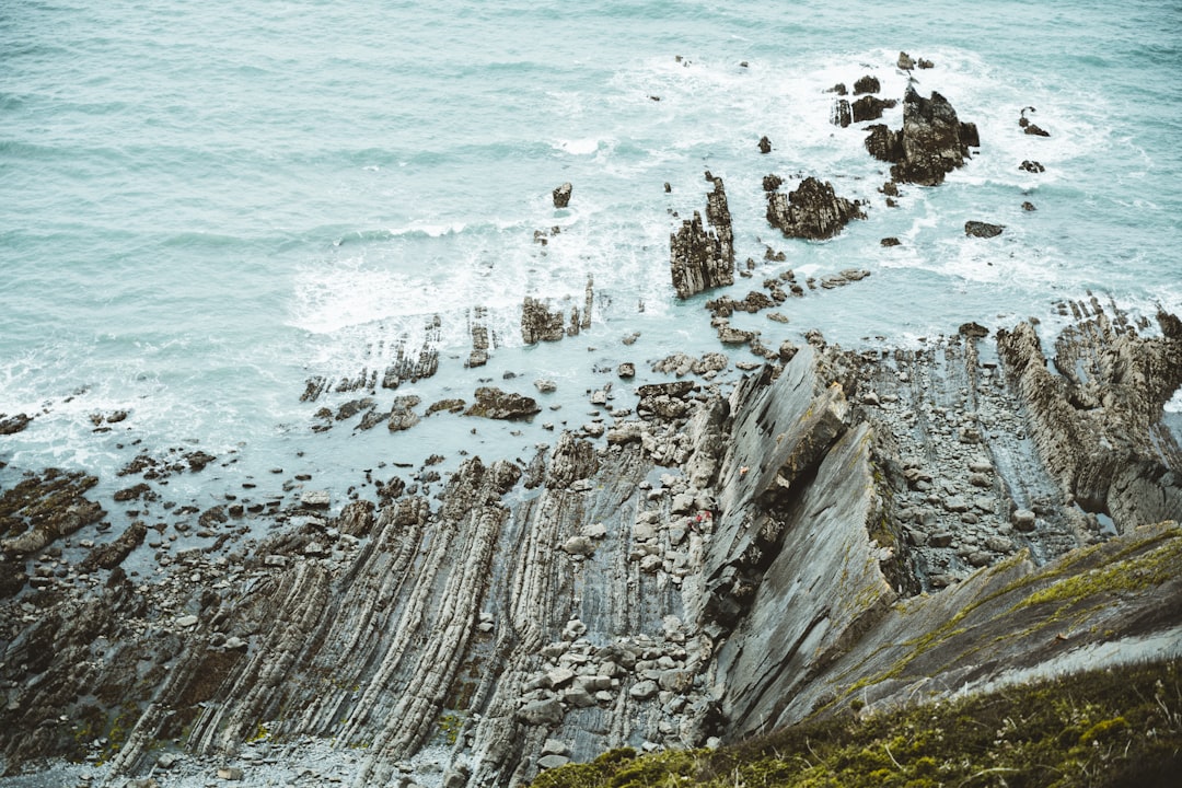 gray rock formation near body of water during daytime