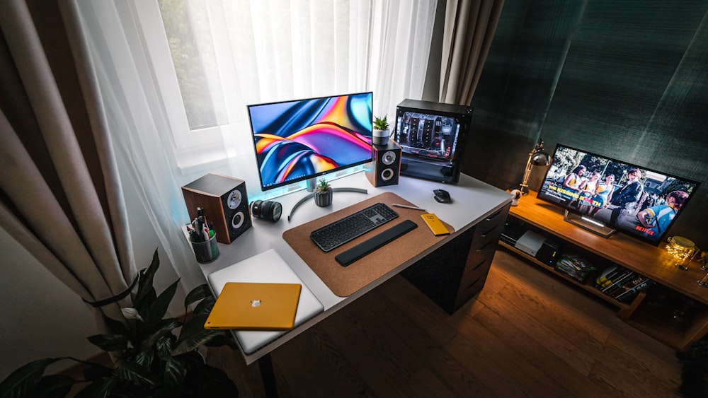 silver macbook on brown wooden table