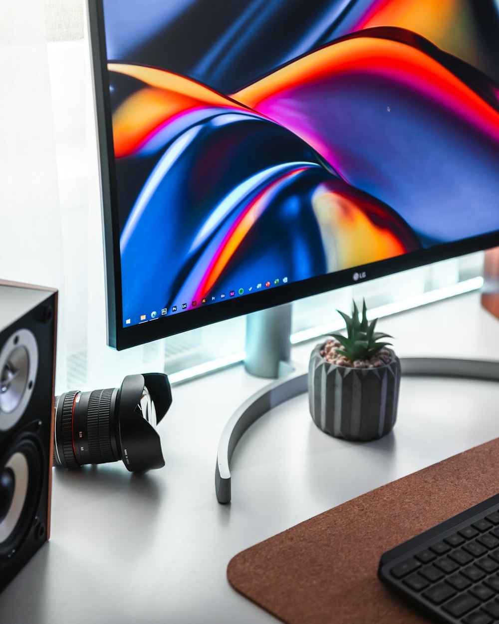 black flat screen computer monitor beside black and white headphones