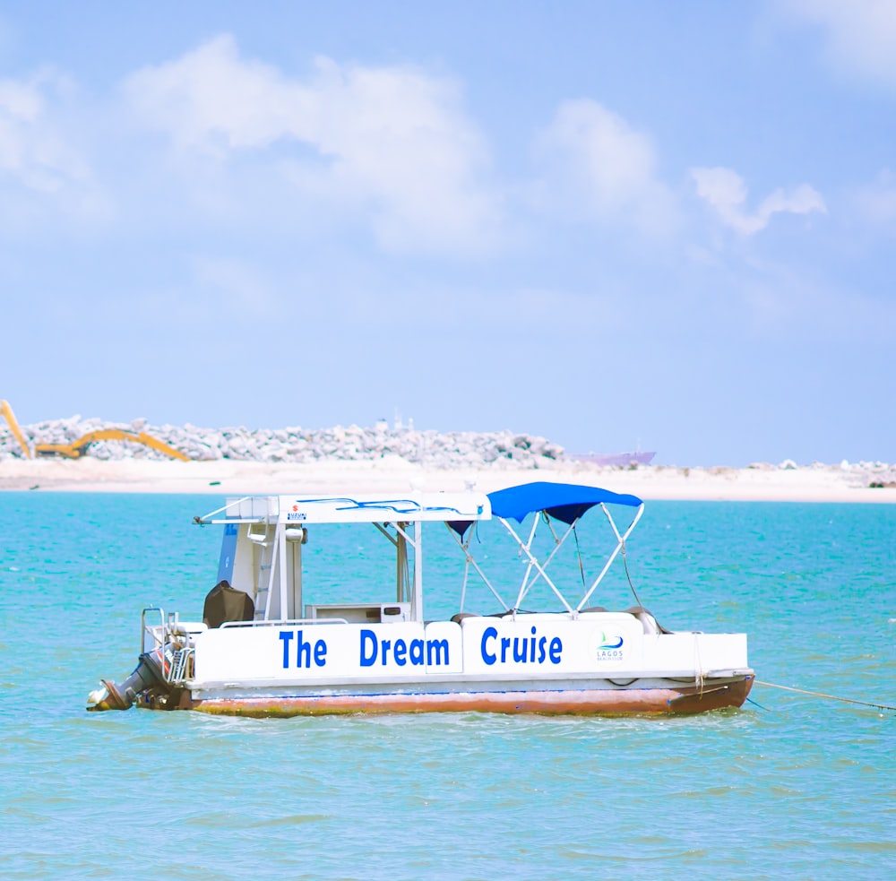 white and blue boat on sea during daytime