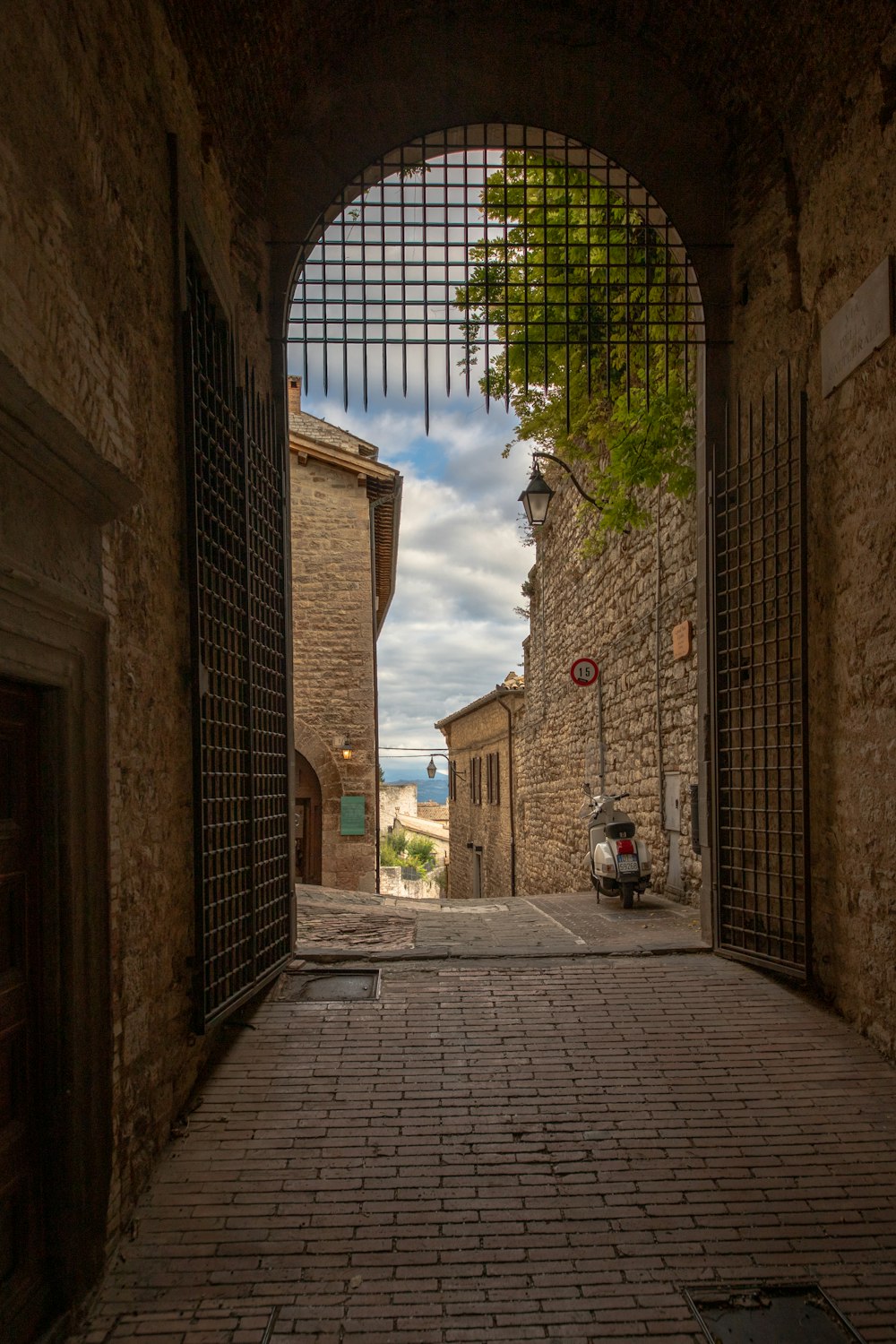 brown brick building with black metal gate