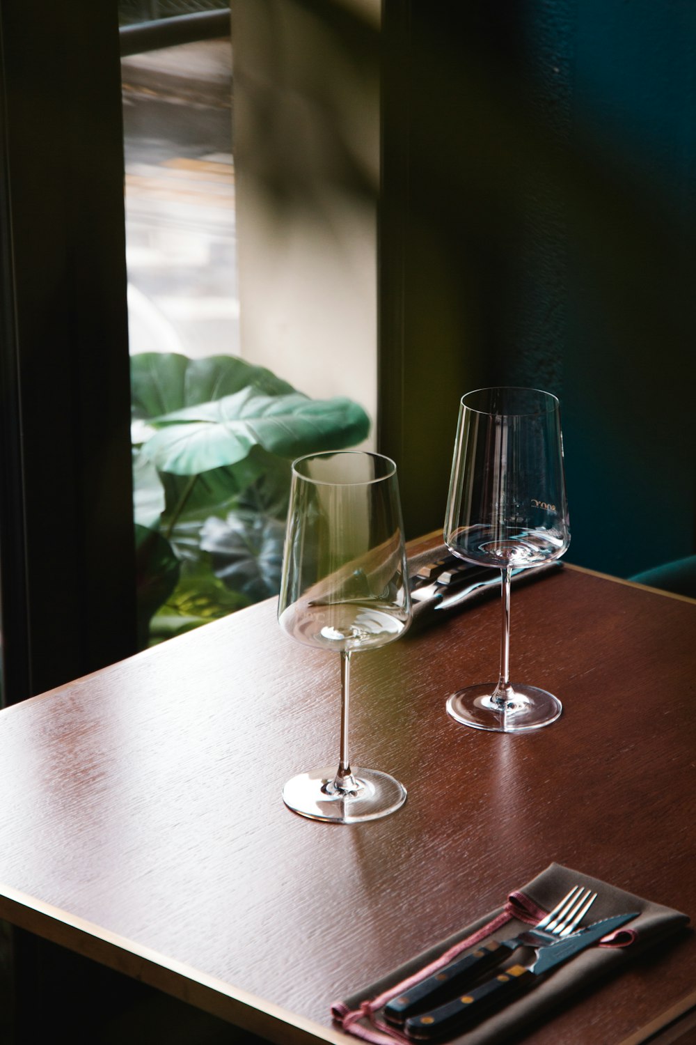 clear wine glass on brown wooden table