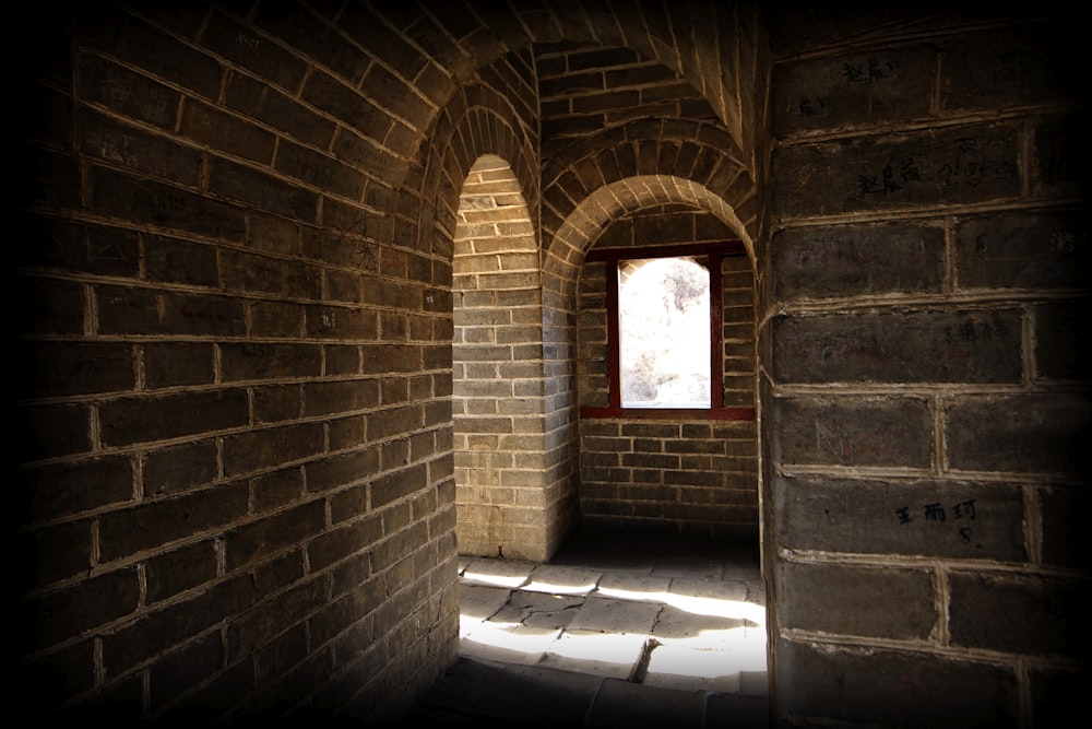 brown brick wall with red wooden door