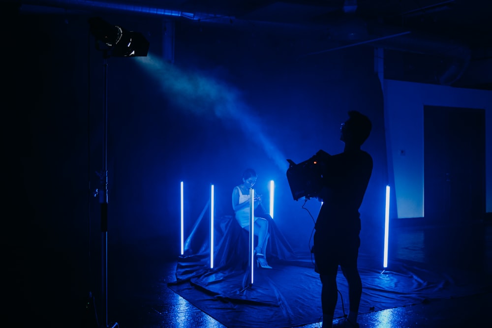 man in black jacket standing on stage