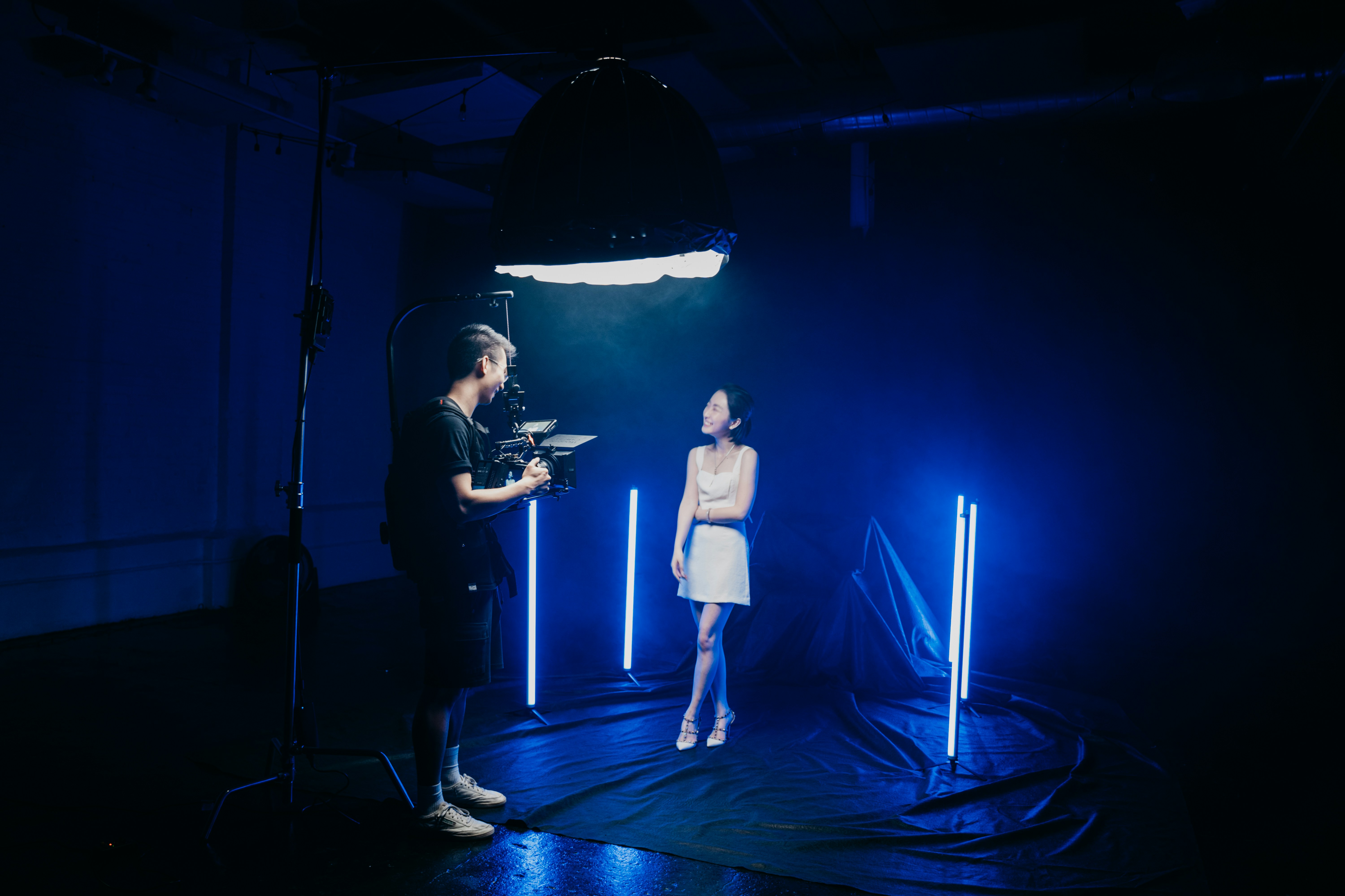 man in black shirt singing on stage