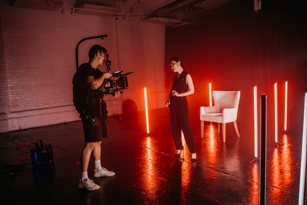 man and woman standing on red floor