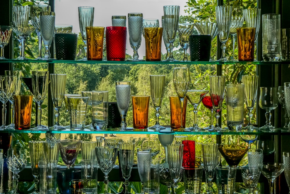 clear drinking glasses on glass shelf