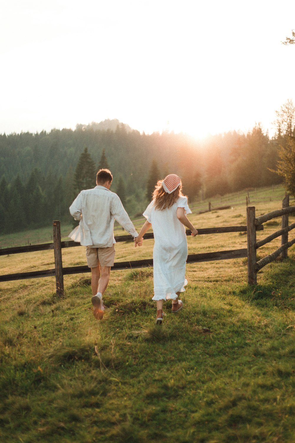 man and woman standing on green grass field during daytime