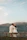 Couple enjoying panoramic mountain views with traditional Berber village in the background