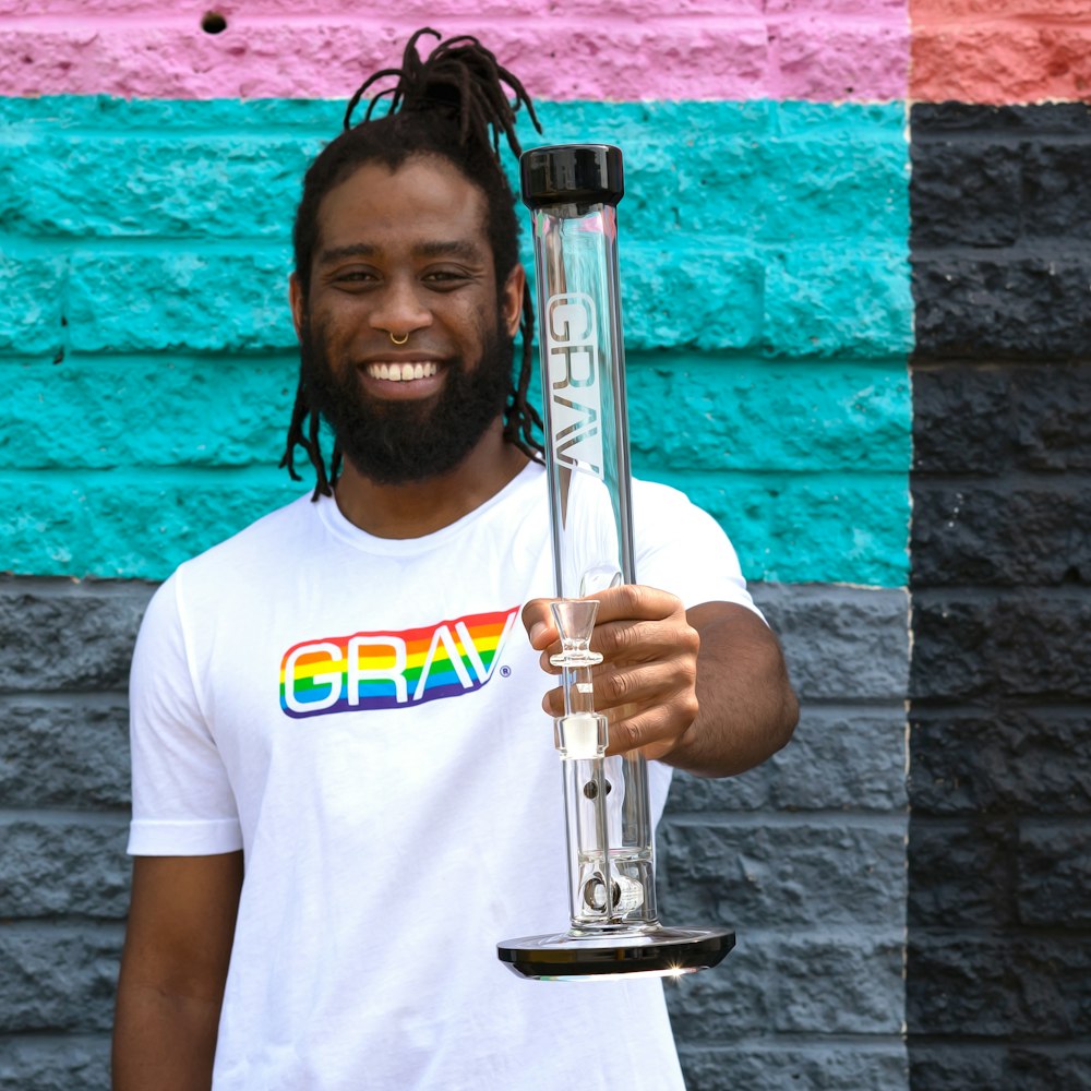 man in white crew neck t-shirt holding trophy