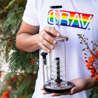 Elegant percolator bong with clear glass and smooth curves on white background