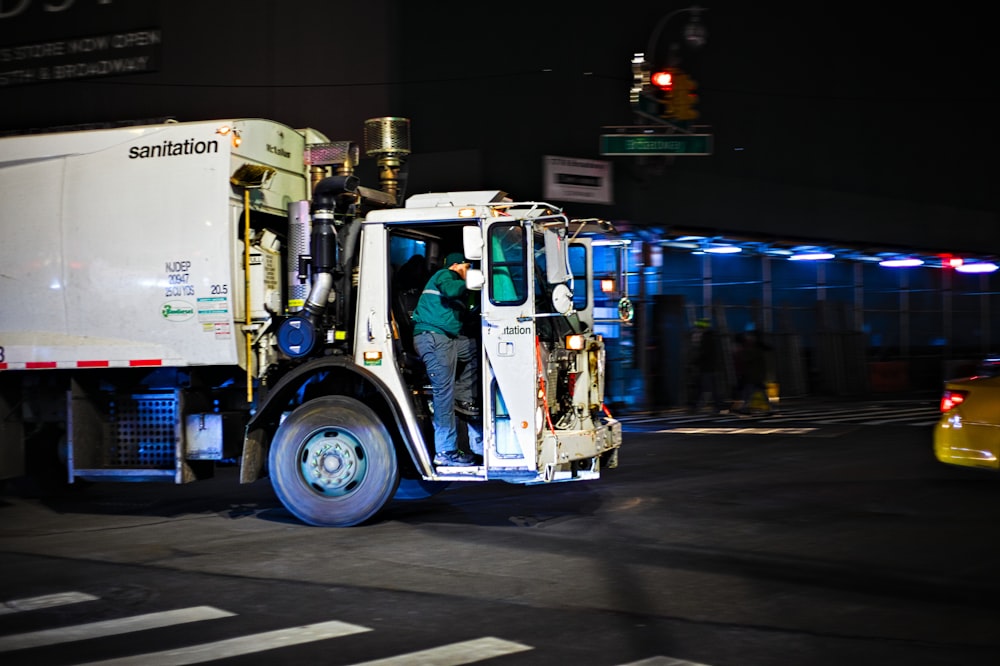 white and blue truck on road during nighttime