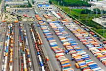 Aerial view of a busy logistics hub with trucks and containers in Mali.