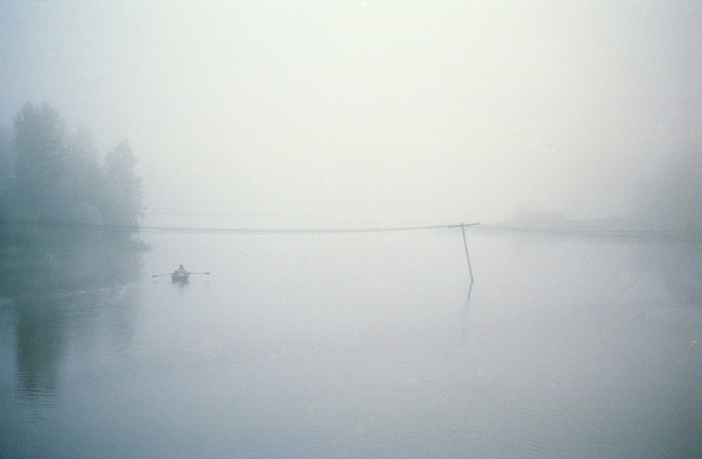 black fishing rod on white fog