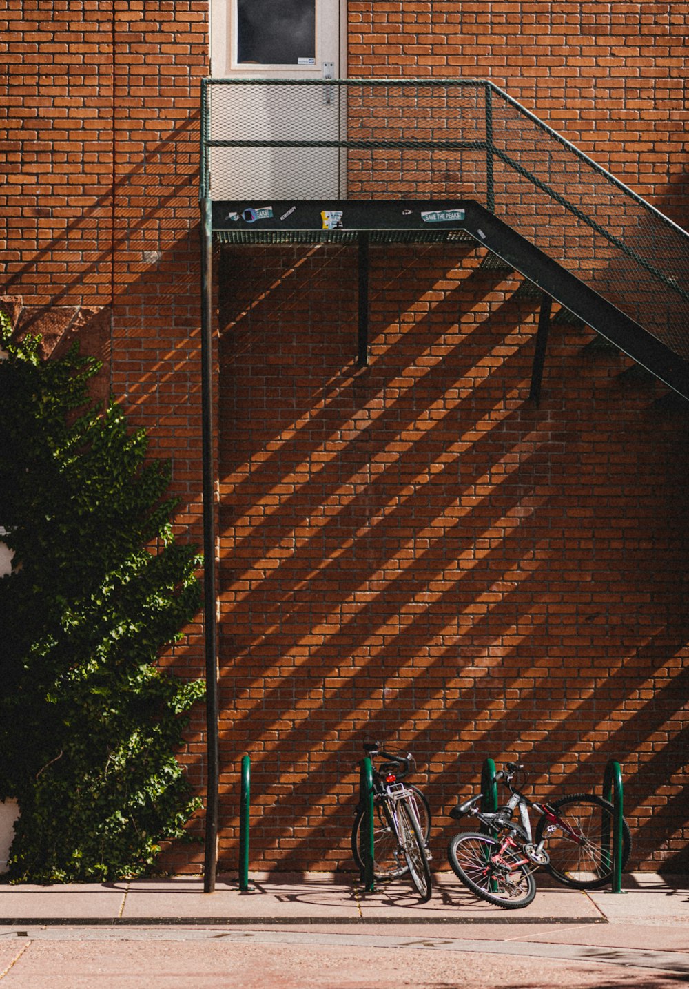 blue and black bicycle on brown brick wall