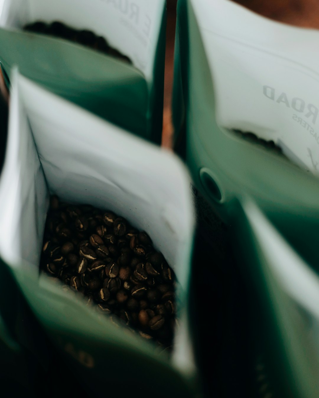 brown coffee beans in white plastic bag