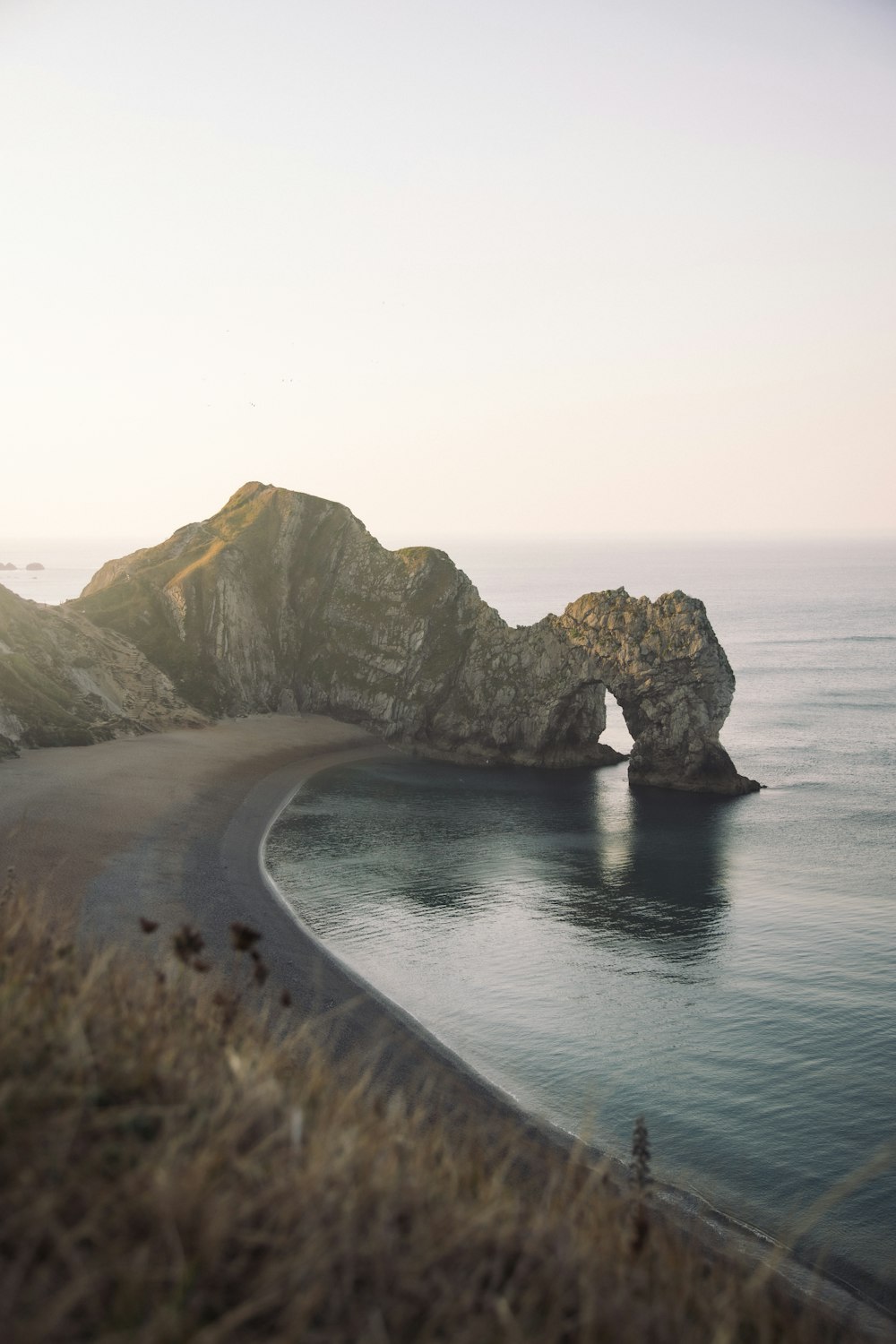 brown rock formation on sea during daytime