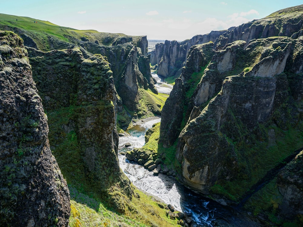 green and gray mountain beside river during daytime