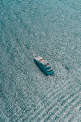 A sleek efoil gliding over deep navy waters under a clear sky, framed by a minimalist yacht deck.