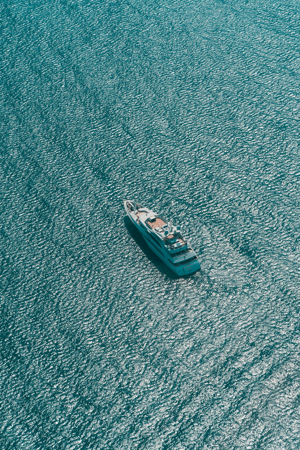 white and blue boat on blue textile