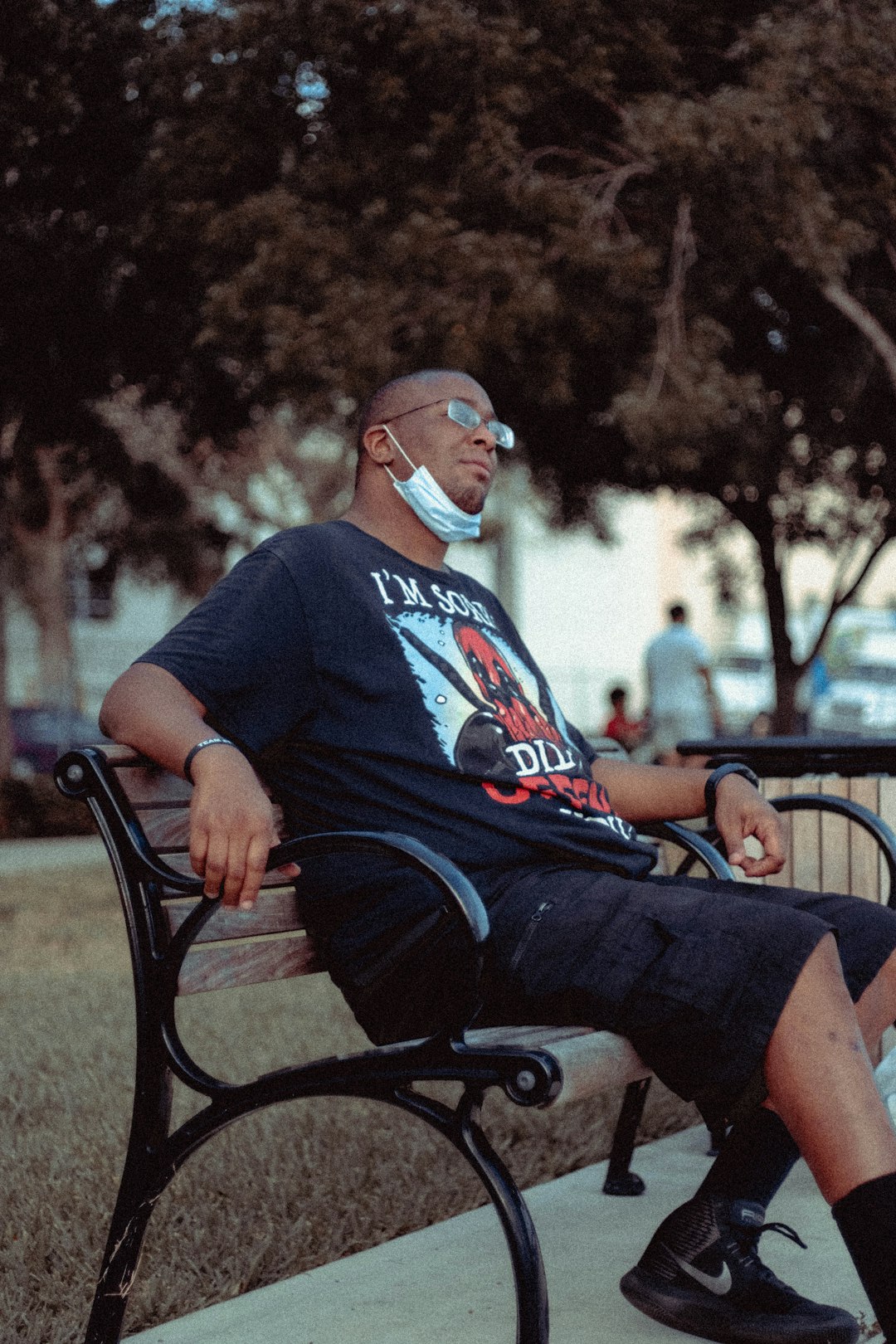 man in black crew neck t-shirt sitting on black metal bench