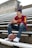 boy in red and yellow crew neck t-shirt and blue denim jeans sitting on stairs