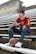 boy in red and yellow crew neck t-shirt and blue denim jeans sitting on stairs