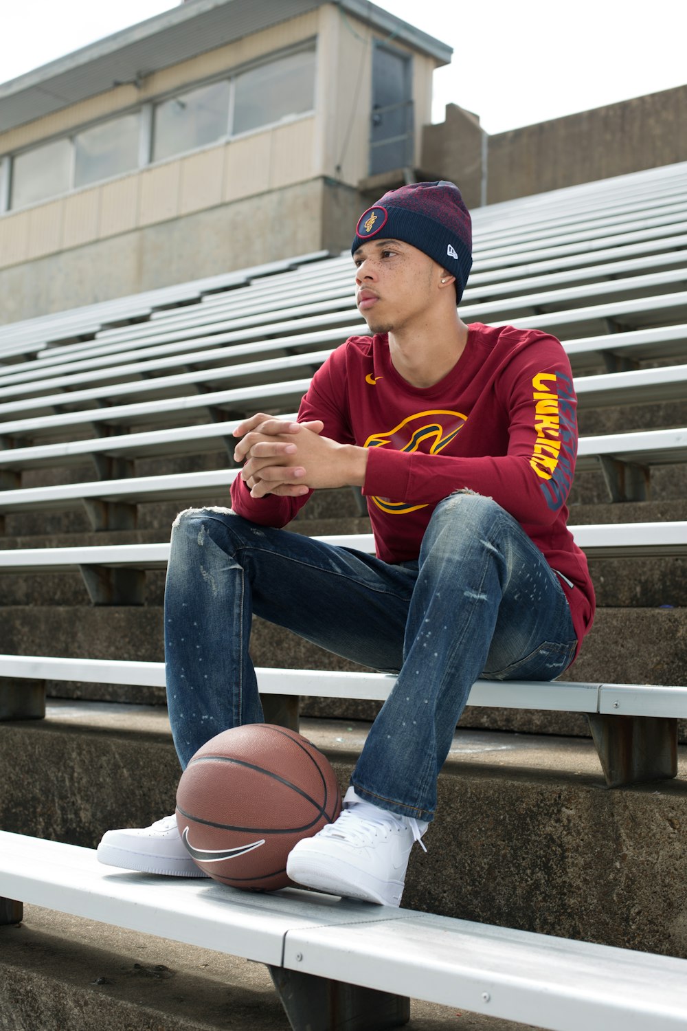 boy in red and yellow crew neck t-shirt and blue denim jeans sitting on stairs