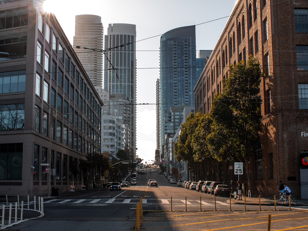 people walking on sidewalk near high rise buildings during daytime