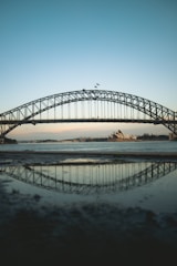 black metal bridge over the sea during daytime