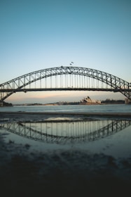 black metal bridge over the sea during daytime