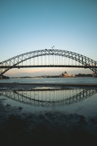 black metal bridge over the sea during daytime