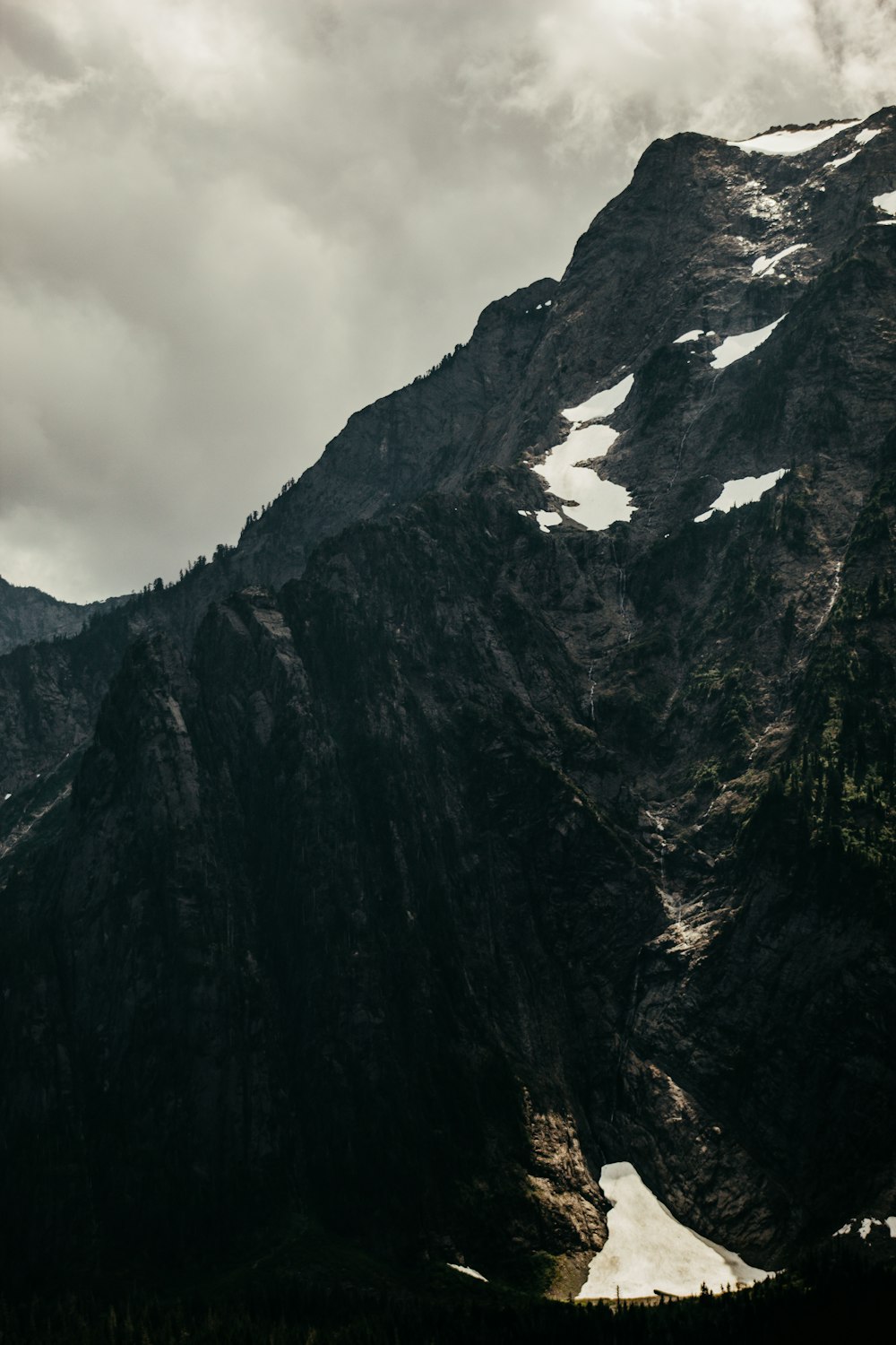 gray and black mountain under white clouds