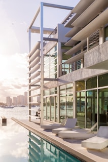 Sunlit view of Adriya Pik’s sleek exterior with gold-accented balconies