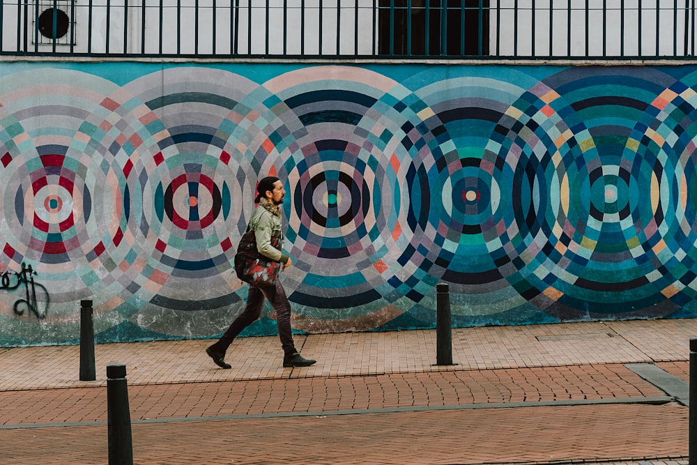 woman in brown coat walking on sidewalk