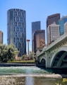 white bridge over river near city buildings during daytime